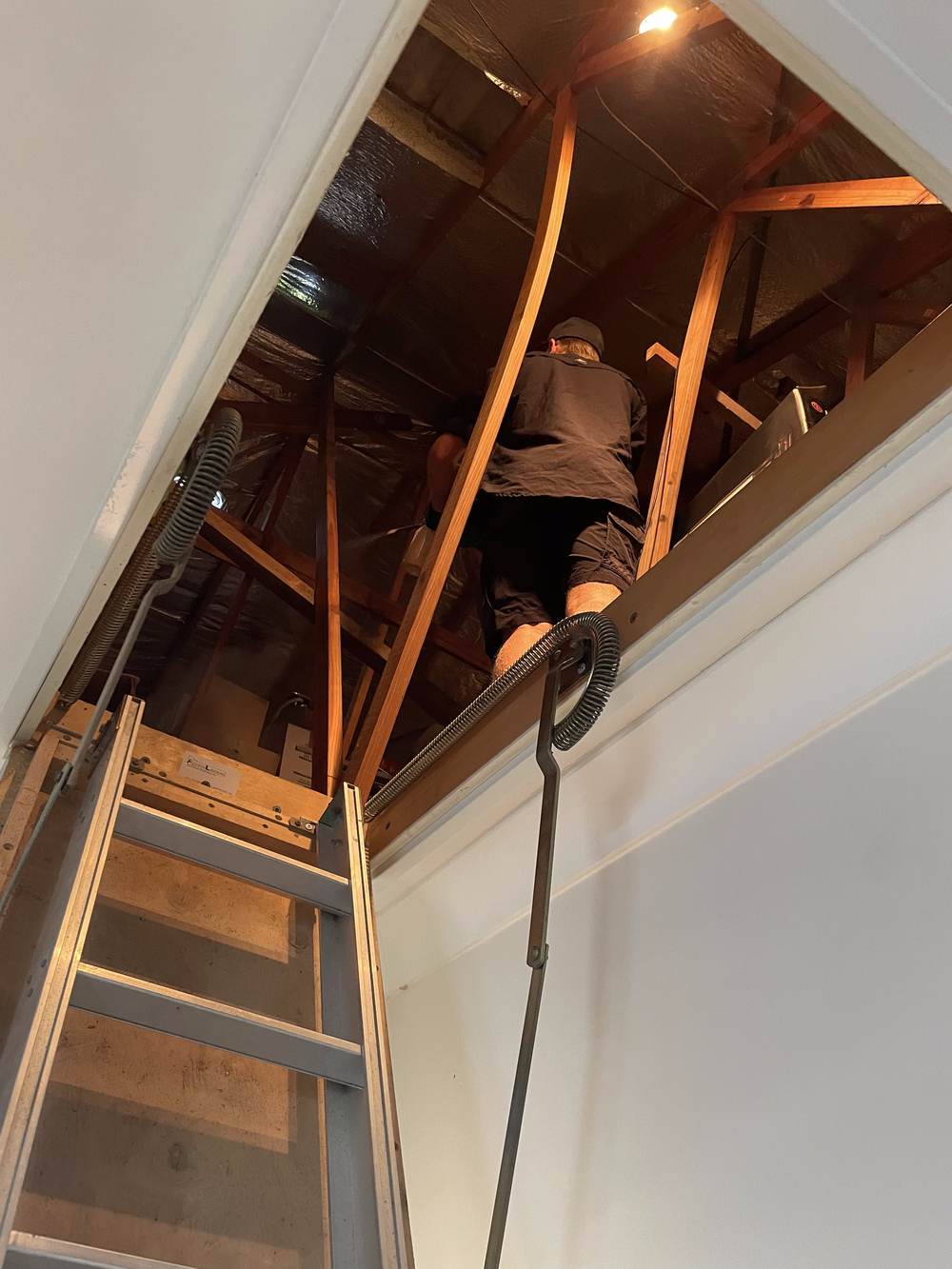pest control Gold Coast technician entering a roof void through the manhole CPH Services Gold Coast